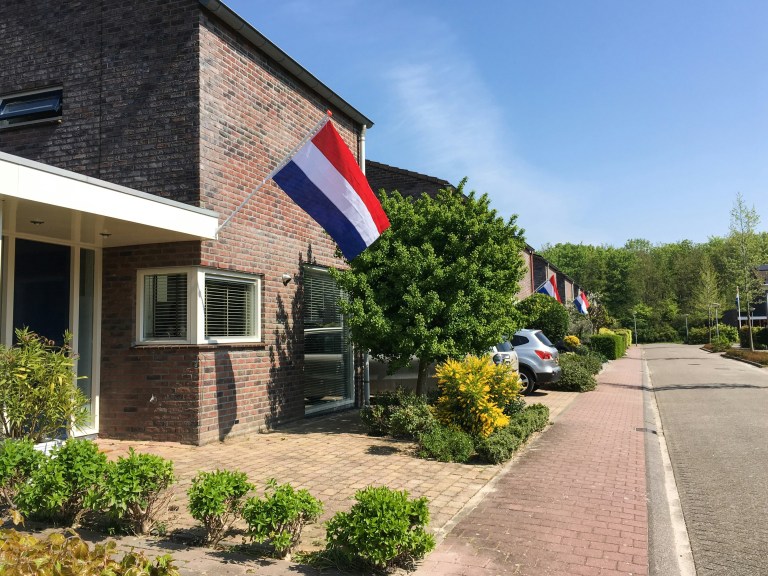 A bulding with a Dutch flag, Employment office in the Netherlands, representing the employment regulations and changes in the Netherlands employment law.