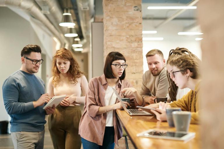 Employees collaborating in a modern office to enhance employee engagemen