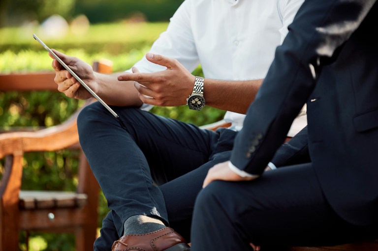 Two people looking at a tablet ready to terminate employment.