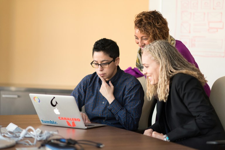 Colleagues from diverse cultural backgrounds building a sense of belonging at work through shared human values.
