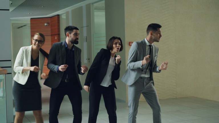 Colleagues dancing in an inclusive workplace culture, representing cultural inclusion.