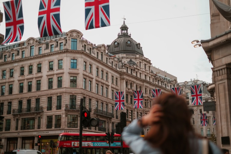 Payroll outsourcing UK in London city centre with Union Jack flags displayed along the street, symbolising compliant UK payroll management services