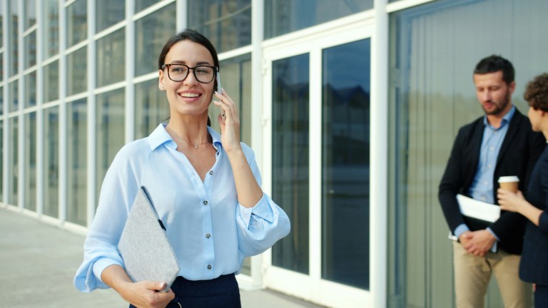 Businesswoman handling payroll compliance matters during a phone call