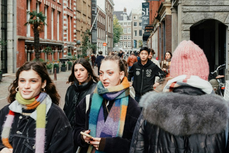 People on the street in Amsterdam, representing moving to the Netherlands.