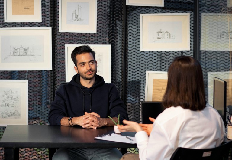 Manager conducting a stay interview with an employee in a one-to-one meeting room