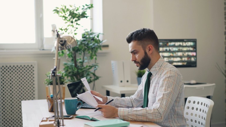 Foreign employer reviewing freelance contract tax risk Netherlands documents at a desk
