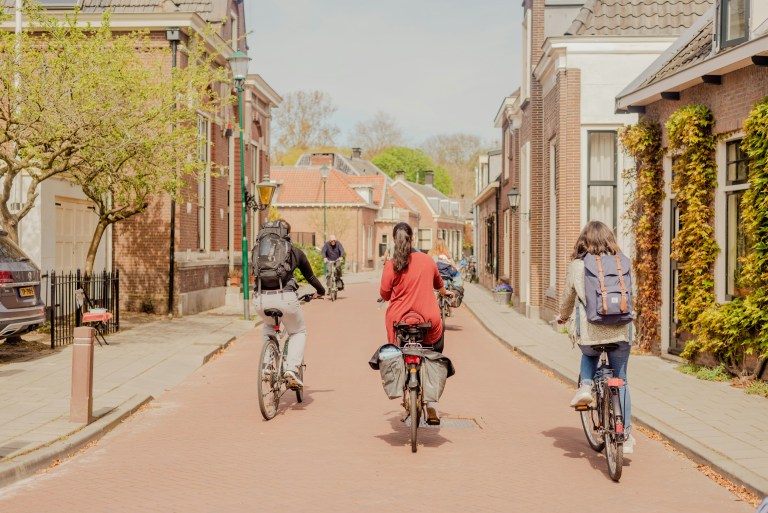 Expats riding bikes representing living and working in the Netherlands