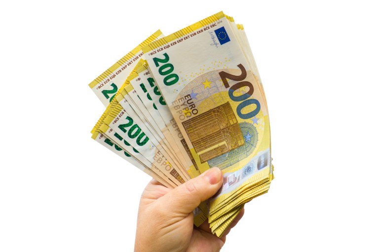 Euros in hand representing 13th Month salary Netherlands